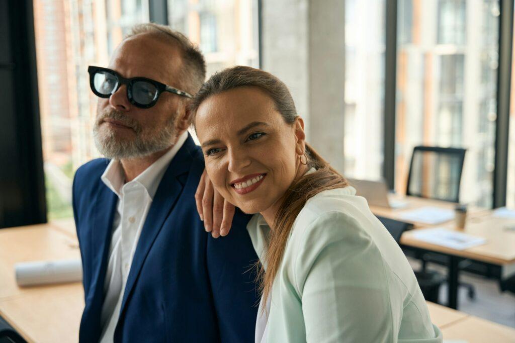 Joyous woman having friendly relations with her office coworker